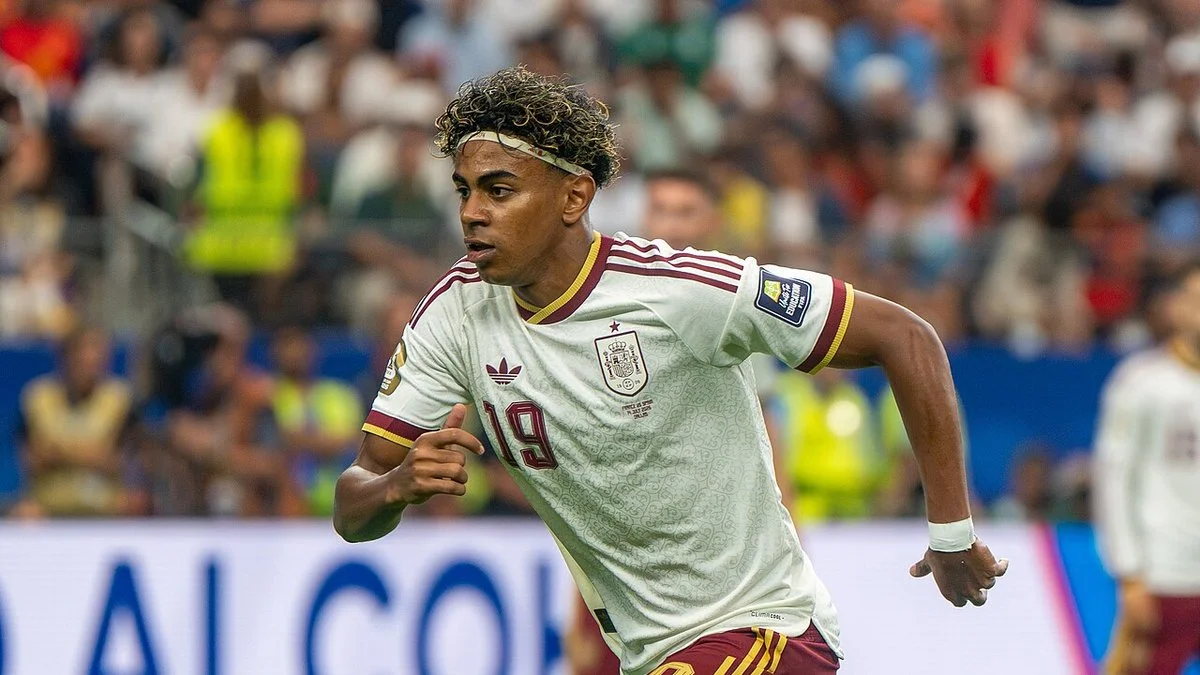 Lamine Yamal in Spain's away shirt running during a match