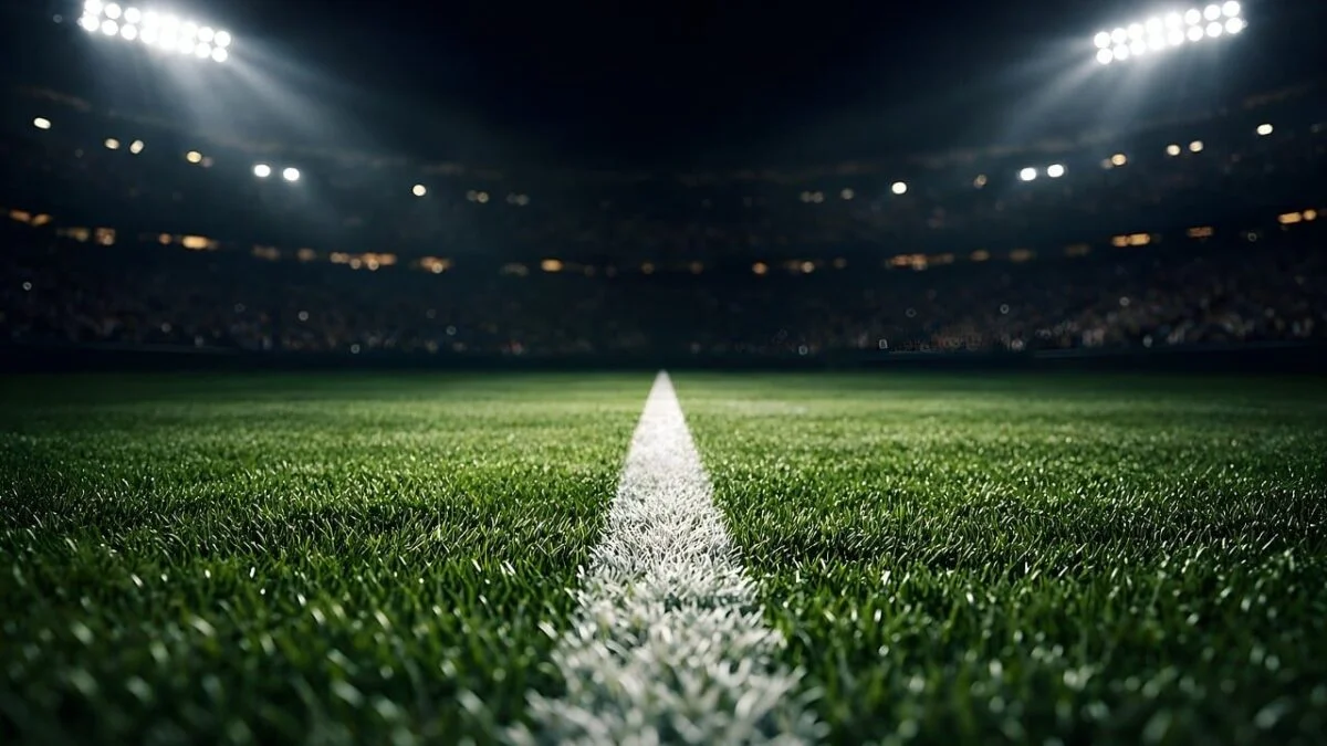 A floodlit football stadium at night